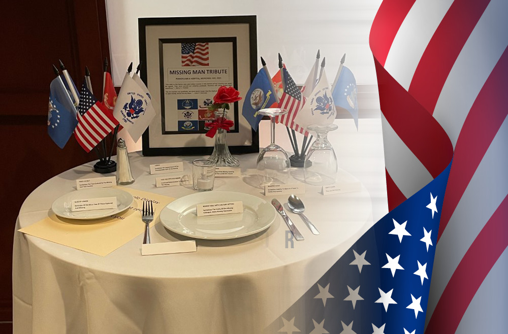 The Missing Man Table, with flags and place-settings, displayed in the Pennsylvania Hospital cafeteria